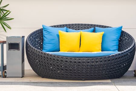 Outdoor patio in the garden with sofa chair and pillow decoration for take a relax