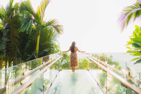 Portrait beautiful young asian women happy smile around outdoorn happy smile relax around tropical nature beach sea with palm treeの写真素材