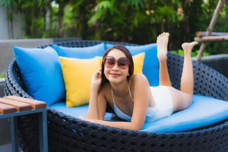Portrait beautiful young asian women happy smile relax around outdoor swimming pool in hotel resort...