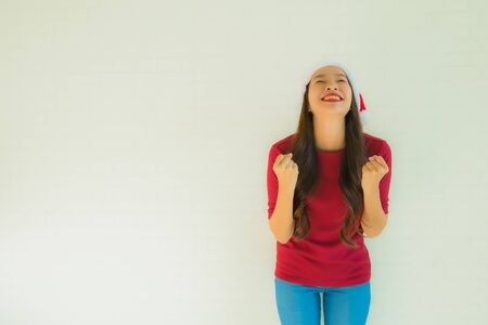 Portrait beautiful young asian women wearing santa hat for celebration in christmas anniversary dayの写真素材