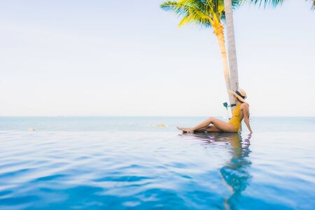 Portrait beautiful young asian women happy smile relax around outdoor swimming pool in hotel resort for travel vacationの写真素材