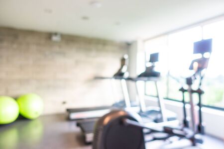 Abstract blur gym room interior with fitness equipment for backgroundの写真素材