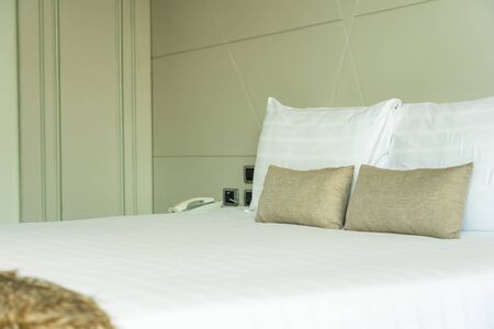 White comfortable pillow on bed decoration interior of bedroomの写真素材