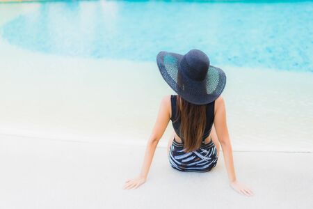 Portrait beautiful young asian women happy smile relax around swimming pool neary sea beach ocean in...