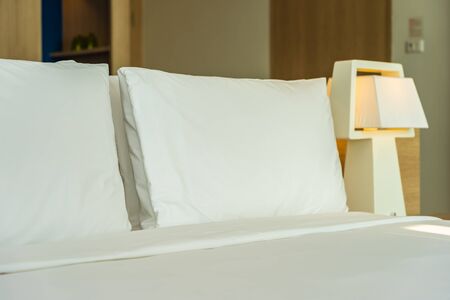 Pillow and blanket on bed with light lamp decoration interior of bedroomの写真素材