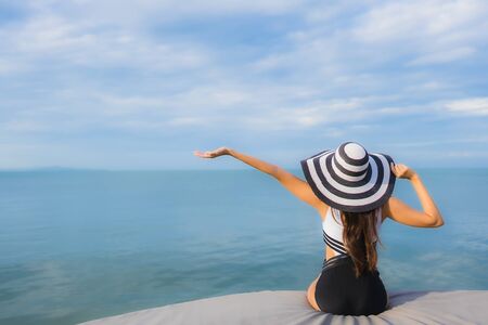 Portrait beautiful young asian women relax smile happy around sea beach ocean for vacation travel in holidayの写真素材