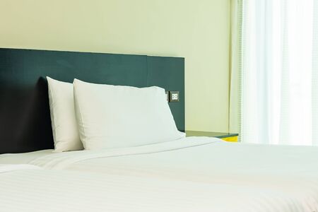 Pillow and blanket on bed with light lamp decoration interior of bedroomの写真素材