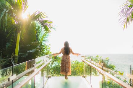 Portrait beautiful young asian women happy smile around outdoorn happy smile relax around tropical nature beach sea with palm treeの写真素材
