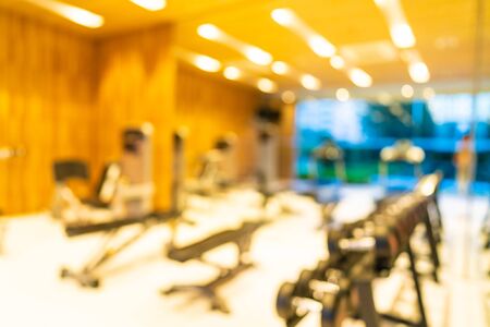Abstract blur gym room interior with fitness equipment for background