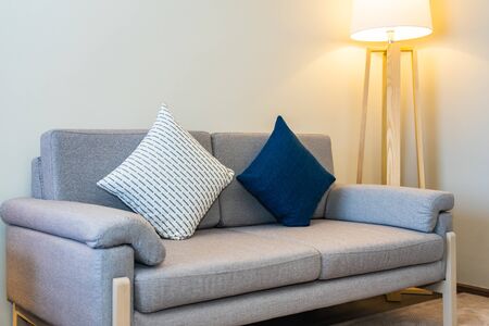 Comfortable pillow on sofa decoration with light lamp interior of living room areaの写真素材