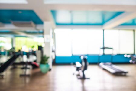 Abstract blur gym room interior with fitness equipment for backgroundの写真素材