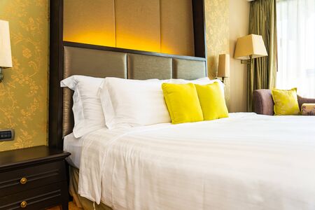 Pillow and blanket on bed with light lamp decoration interior of bedroomの写真素材