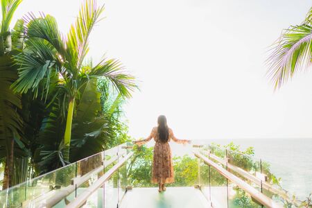 Portrait beautiful young asian women happy smile around outdoorn happy smile relax around tropical nature beach sea with palm treeの写真素材