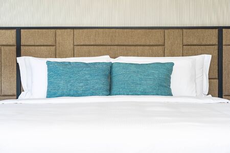 White comfortable pillow on bed decoration interior of bedroom