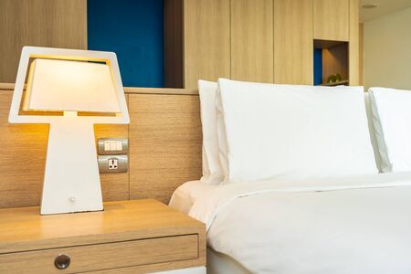 Pillow and blanket on bed with light lamp decoration interior of bedroomの写真素材