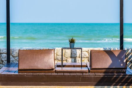 Pillow on sofa bed with lounge around beach ocean sea and blue sky for travel vacation