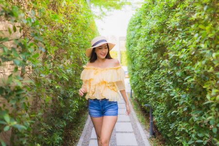 Portrait young asian woman happy smile relax around outdoor nature garden viewの写真素材