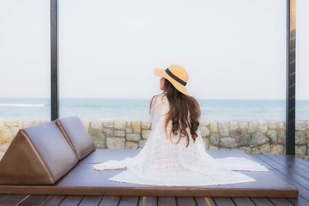 Portrait young asian woman happy smile relax around beach sea ocean for travel vacationの写真素材