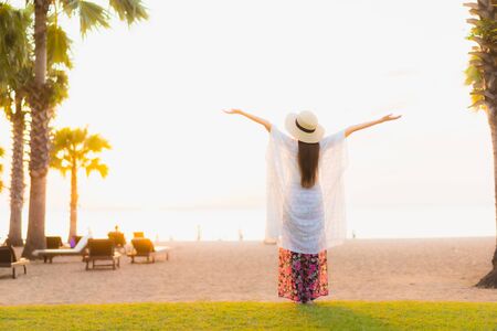 Portrait beautiful young asian women happy smile relax around beach sea ocean at sunset or sunrise time for travel vacationの写真素材