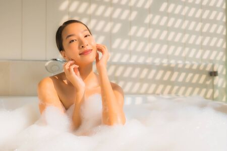 Portrait young asian woman relax take a bath in bathtub for spa conceptの写真素材