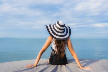 Portrait beautiful young asian women relax smile happy around sea beach ocean for vacation travel in holidayの写真素材