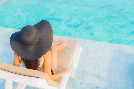 Portrait beautiful young asian woman happy smile relax around outdoor swimming pool in hotel resort for travel vacationの写真素材