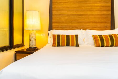 White comfortable pillow on bed decoration interior of bedroomの写真素材