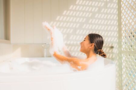 Portrait young asian woman relax take a bath in bathtub for spa conceptの写真素材