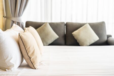 White comfortable pillow on bed decoration interior of bed room in hotel resortの写真素材