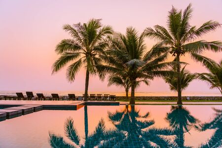 Beautiful nature with palm tree around outdoor swimming pool in hotel resort nearly sea ocean beachの写真素材