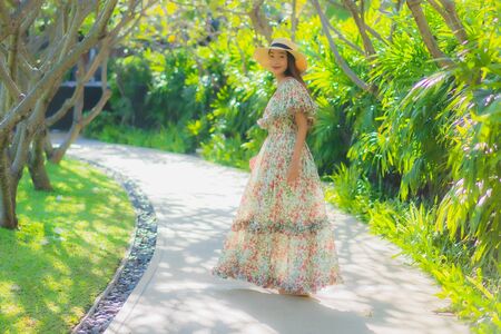 Portrait beautiful young asian woman walking with happy enjoy around outdoor garden viewの写真素材