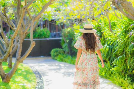 Portrait beautiful young asian woman walking with happy enjoy around outdoor garden viewの写真素材