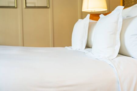 Comfortable white pillow on bed decoration in bedroom interiorの写真素材