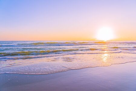 Beautiful tropical nature beach sea ocean with sunset or sunrise for travel vacation