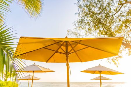 Umbrella and chair around beach sea ocean at sunset or sunrise time for travel vacationの写真素材