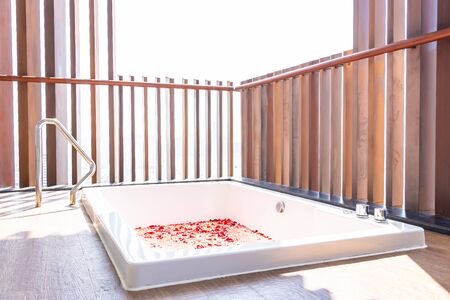 Red rose flower on water in bathtub decoration interior for take a bath and relax