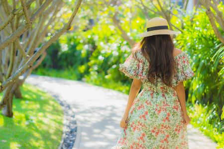 Portrait beautiful young asian woman walking with happy enjoy around outdoor garden viewの写真素材