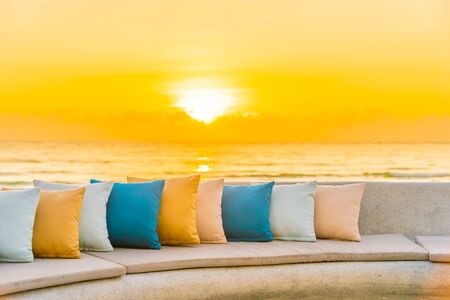 Comfortable pillow on sofa chair around outdoor patio with sea ocean beach view for travel vacation...