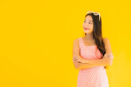 Portrait beautiful young asian woman smile happy on yellow isolated background