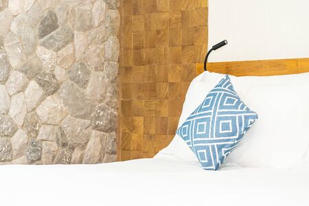 Comfortable white pillow on bed decoration in bedroom interiorの写真素材