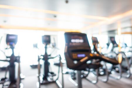 Abstract blur fitness equipment in gym room interior for background