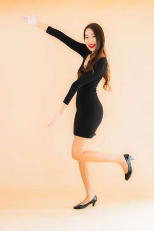 Portrait beautiful young asian woman happy smile in action on color isolated backgroundの写真素材