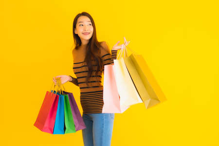 Portrait beautiful young asian woman happy smile with a lot of color shopping bag from department...