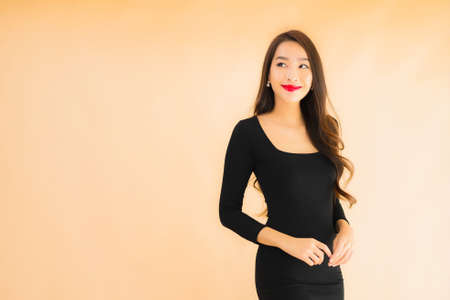 Portrait beautiful young asian woman happy smile in action on color isolated backgroundの写真素材