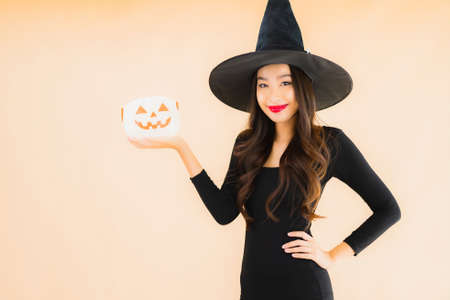 Portrait beautiful young asian woman wear halloween costume on color isolated backgroundの写真素材