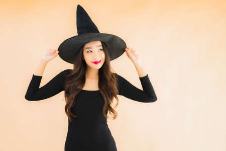 Portrait beautiful young asian woman wear halloween costume on color isolated backgroundの写真素材