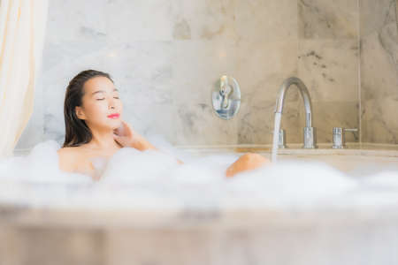 Portrait of beautiful young asian woman in a bathtubの写真素材