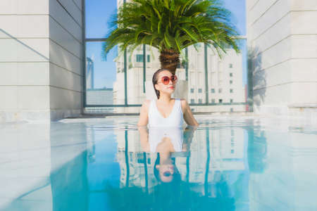 Portrait beautiful young asian woman inside a swimming poolの写真素材