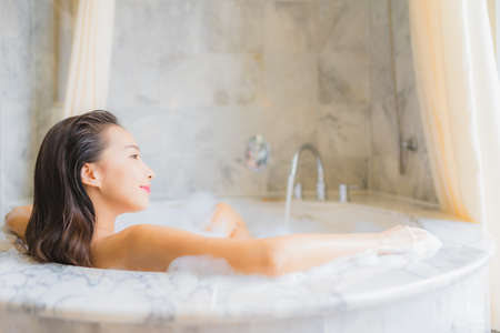 Portrait beautiful young asian woman relax take a bath in bathtub in bathroom interior