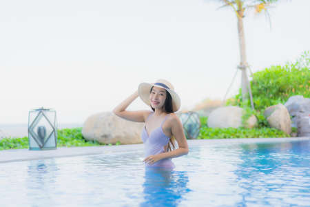 Portrait beautiful young asian woman relax around swimming pool in hotel resort for leisure in...